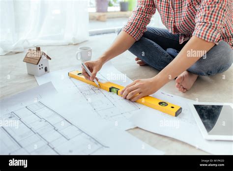 Young Handsome Male Asian Architect Working At Home On The Floor Stock