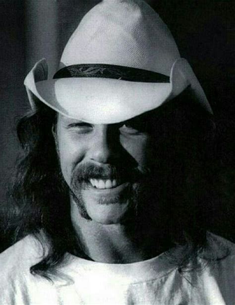 A Man Wearing A Cowboy Hat With Long Hair