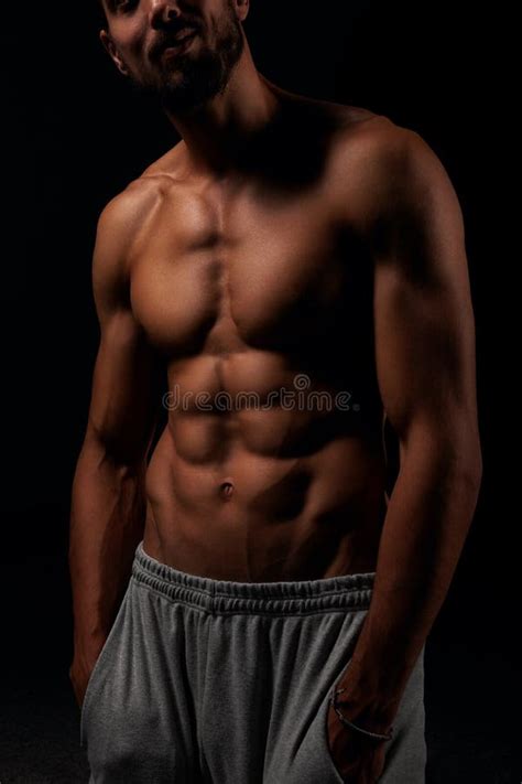 Young Man Showing His Six Pack Abs With His Hand In The Pockets Stock
