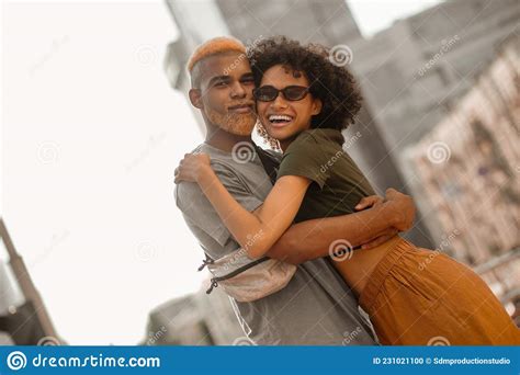 A Happy Dark Skinned Couple In The Street Looking Excited Stock Photo