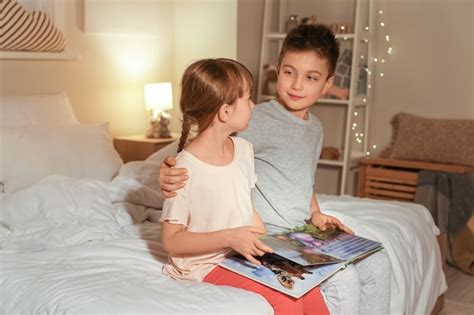 Premium Photo Little Children Reading Bedtime Story At Home