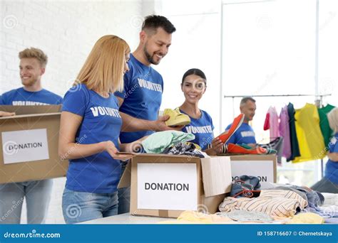 Team Of Volunteers Collecting Donations In Boxes Stock Image Image Of