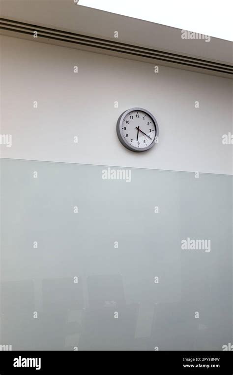 Clock On Wall Of Empty Office Hall Shows Twenty Past Six After End Of
