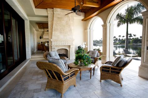 This patio rests beneath a glass roof, allowing sunshine to filter through without subjecting the owners to any inclement weather. 55 Luxurious Covered Patio Ideas (Pictures)
