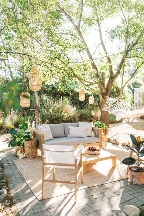 Outdoor Oasis Comfy Chair Lighting Plants Pillows Rug