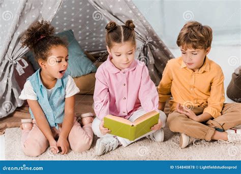Cute Little Children Sitting On Carpet And Stock Photo Image Of