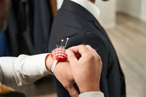 Experienced Tailor Conducting Fitting Session With Client Stock Image