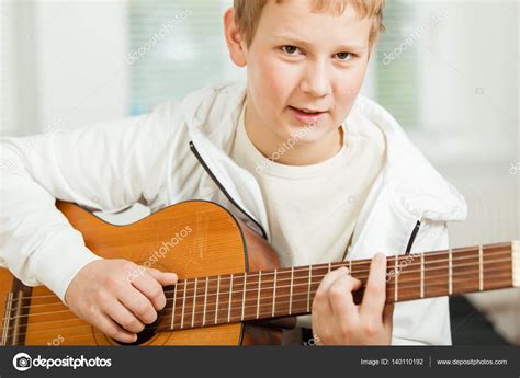 Teenage Boy Playing Guitar Stock Photo By ©jhandersen 140110192