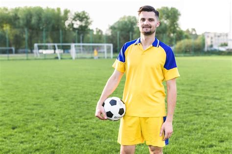 Amateur Football Concept With Man Posing With Ball Photo Free Download