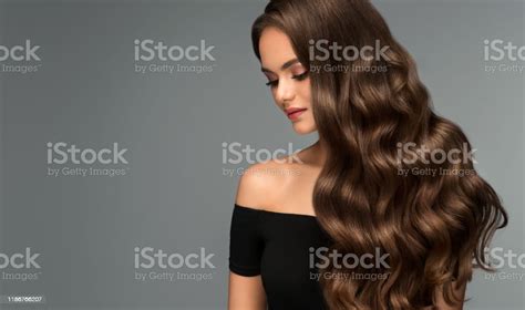 Young Brown Haired Beautiful Model With Long Curly Well Groomed Hair