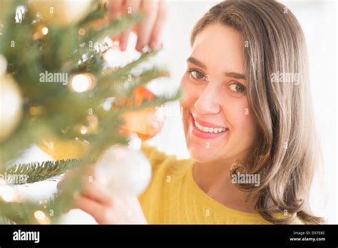 Woman Decorating Christmas Tree Stock Photo Alamy