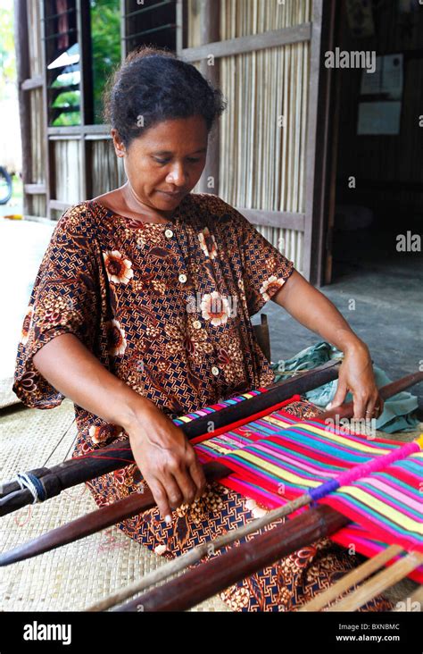 Woman Traditionally Weaving Tais On Backstrap Loom In Timor Leste East