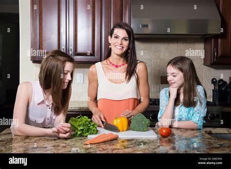 Mom Making Dinner With Her Daughters Stock Photo Alamy