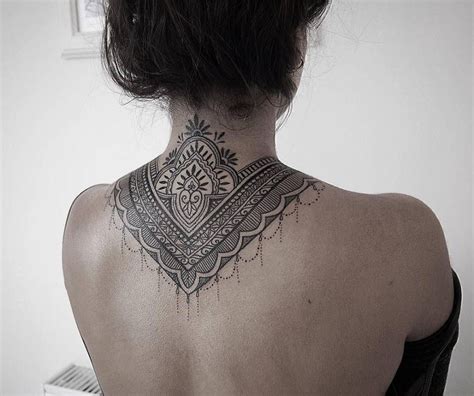 Ornamental Style Tattoo Covering Back Of The Neck And