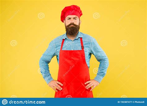Serious Bearded Chef Brutal Male Cook In Hat And Apron Professional Man Cooking Stock Image