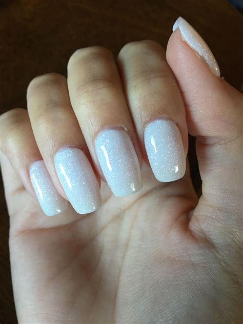 Apply a base over the whole of the nail once more before dipping again. White glitter dip powder nails