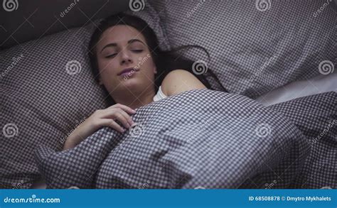 Female In Her 20s Wakes Up In The Morning In A Bed Girl Is Stretching Herself After Sleeping