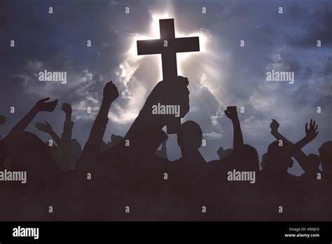 Group Of Christian People Praying To Jesus Christ With Dramatic Sky