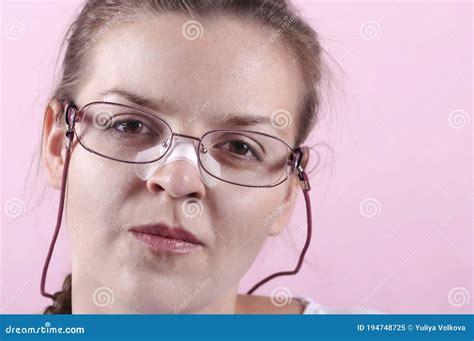 A Girl With Glasses Her Nose Is Sealed With A Plaster Stock Image