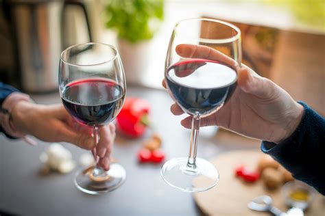 Close Up Photo Of Two People Toasting With Red Wine · Free Stock Photo