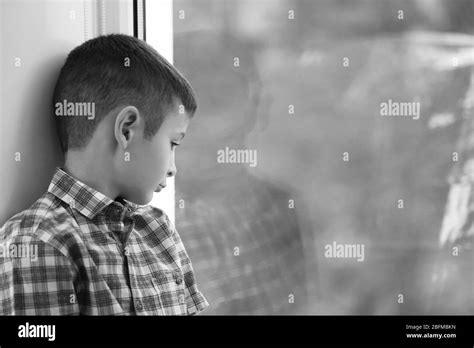 Sad Boy Sitting Near Window Stock Photo Alamy
