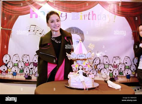 singer and actress gillian chung of hong kong pop duo twins poses with a birthday cake during a