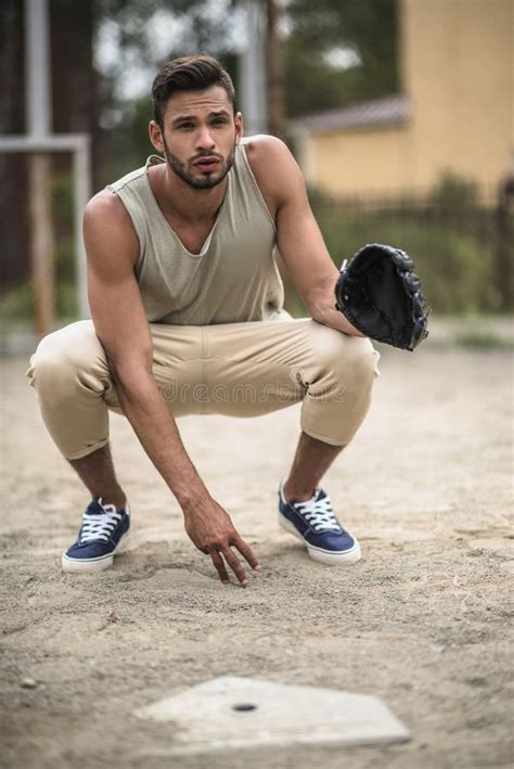 Handsome Baseball Player Ready To Catch Ball On Court Stock Photo