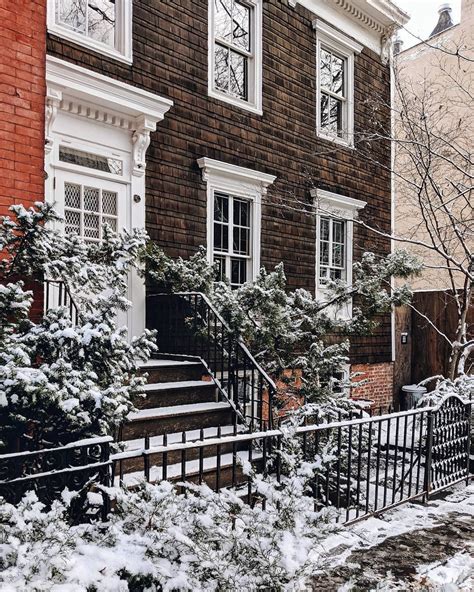 A House With Snow On The Ground And Stairs Leading Up To Its Windows