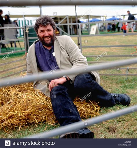 British Cartoonist Steve Bell Sitting In A Pigpen At The Hay Festival