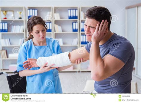 The Doctor And Patient During Check Up For Injury In Hospital Stock