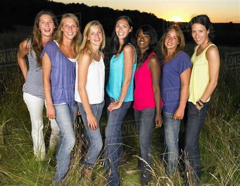 Group Of Girlfriends In A Field Smiling Stock Photo Dissolve