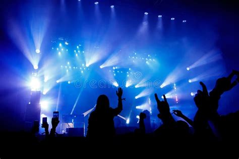 Silhouette Of Crowd Concert Music Fans On Show Raised Hands And