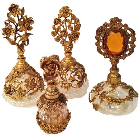 Collection Of Four French Antique Perfume Bottles In Gilded Brass And
