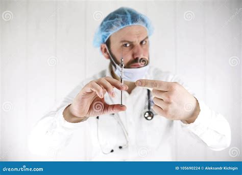 Crazy Bearded Doctor In A White Coat And Old Syringe Stock Photo