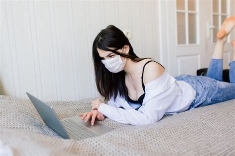 Premium Photo Beautiful Female In Quarantine Wearing Protective Mask And Working At Home
