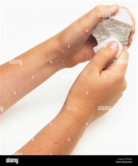 Boy Rubbing Two White Marble Rocks Together Stock Photo Alamy