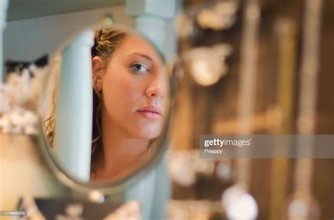 Young Woman Looking At Herself In The Mirror Photo Getty Images