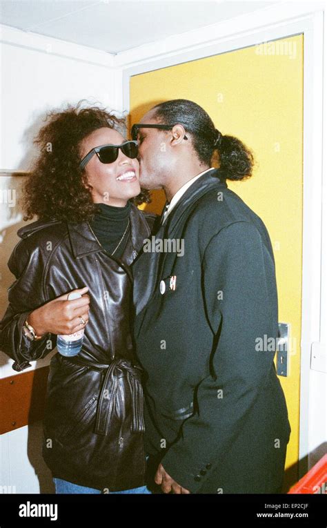 Stevie Wonder Kisses Whitney Houston On The Cheek As They Laugh Backstage At The Nelson Mandela