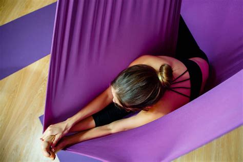 considering branching into aerial yoga here s what you can expect from an aerial yoga class and