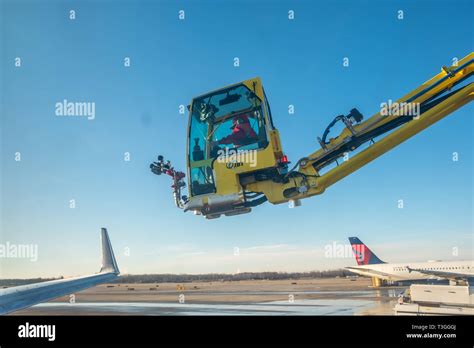 Jet wing being de-iced. Detroit Metro Airport (DTW), USA Stock Photo