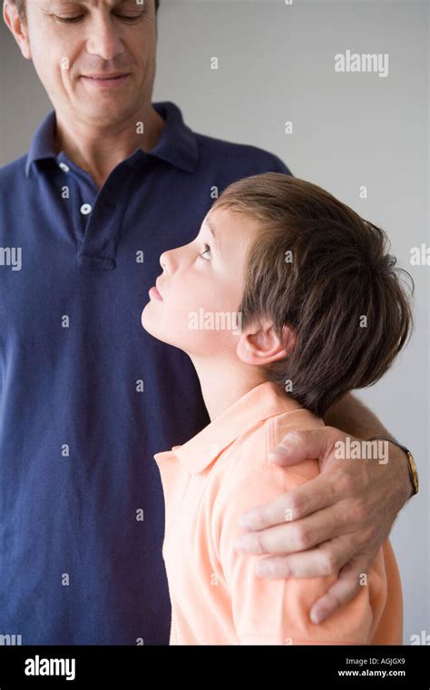 Son Looking Up To Father Stock Photo Alamy