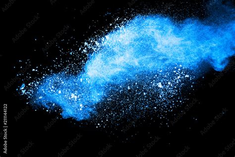 Abstract Blue Dust Explosion On Black Background Freeze Motion Of Blue