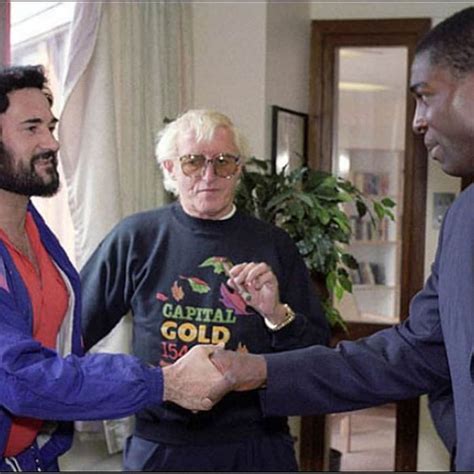 Boxer Frank Bruno Shaking The Hand Of The Yorkshire Ripper While Jimmy Savile Looks On In The