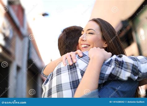 Happy Couple Hugging After Meeting In The Street Stock Photo Image Of