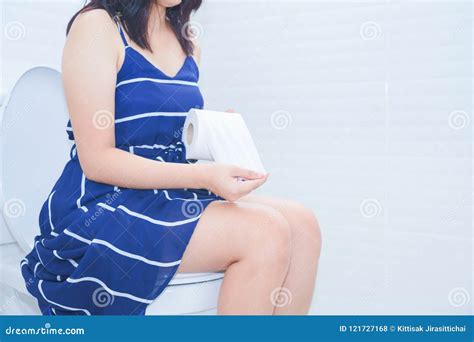 Woman Sitting On Toilet With Toilet Paper Concept Stock Photo Image