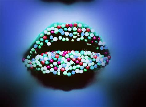 Female Lips With Colorful Candy Close Up Macro In Blue Neon Light Stock