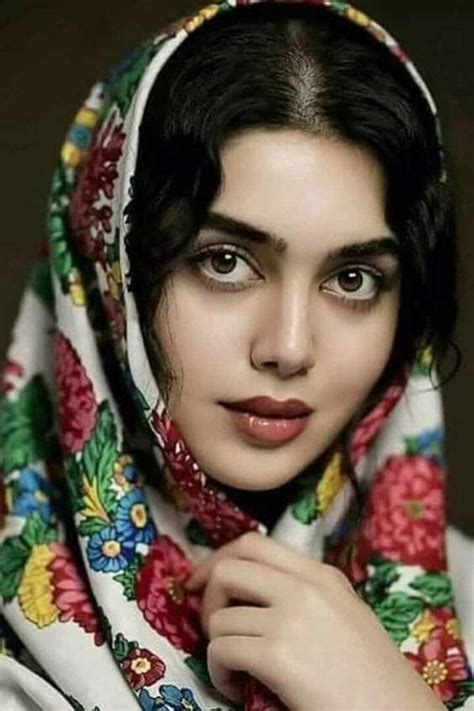 A Woman Wearing A Colorful Shawl And Looking At The Camera With An Intense Look On Her Face