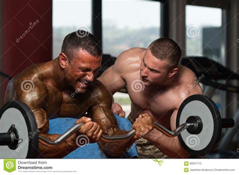 Two Guys Doing Exercise For Biceps In Gym Stock Photo Image Of Abdominal Exercise