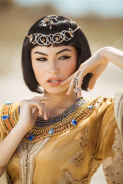 beautiful woman with fashion make up and hairstyle like egyptian queen cleopatra outdoors