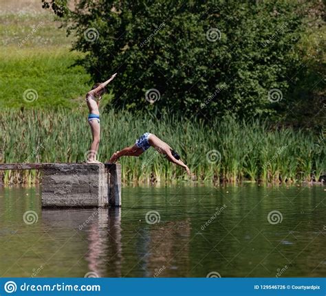 Two Boys Diving In The Lake Stock Photo Image Of Long Water 129546726